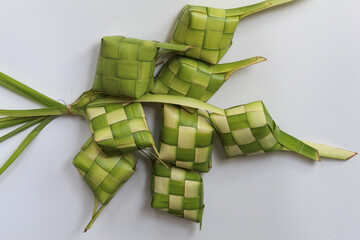 Ketupat wrap, woven young coconut leaves, before cooked. Isolated on white background