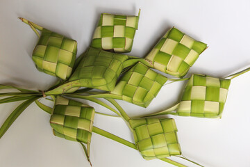 Ketupat wrap, woven young coconut leaves, before cooked. Isolated on white background