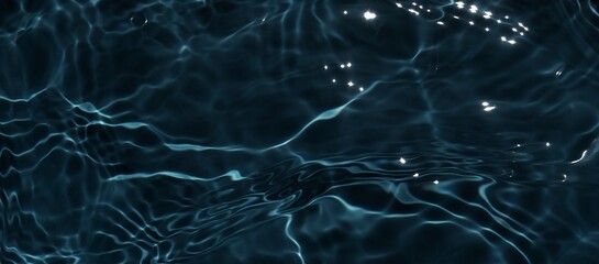 Dark black water surface. Closeup of clear calm water surface texture with ripples, splashes. Dark...