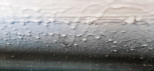 White painted metal surface closeup. Architecture background with dripping white paint on metal...