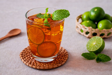 Iced tea with lime and mint leaf