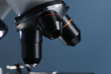 Fototapeta na wymiar One microscope on blue background, closeup view