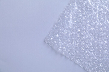 Transparent bubble wrap on gray background, top view. Space for text