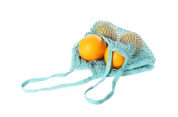 Fotobehang Fresh oranges in string bag isolated on white © New Africa