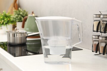 Water filter jug on white countertop in kitchen