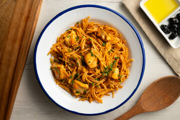 Spanish fideua paella with chicken and vegetables.
