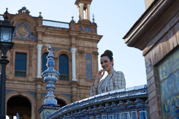 Young and beautiful woman in casual clothes is visiting the famous Plaza de Espana in Seville. The...