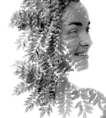 A disappearing black and white double exposure portrait of a smiling woman
