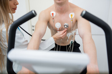 Determined athlete undergoing rigorous cardiac stress test in clinical setting