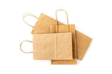 Several kraft paper shopping bags with handles of a variety of sizes isolated on white