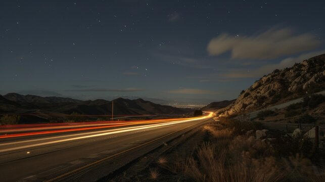 A long exposure shot capturing the streaks of passing car lights on a nighttime highway
