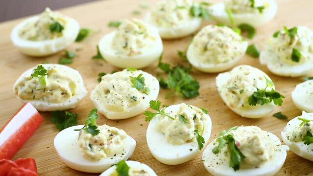 stuffed eggs, deviled eggs on a wooden table