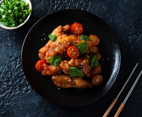 Pork in sweet and sour sauce and sesame seeds. A traditional Chinese dish.