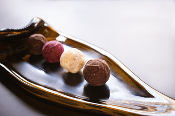 multi-colored truffle candies on a glass plate