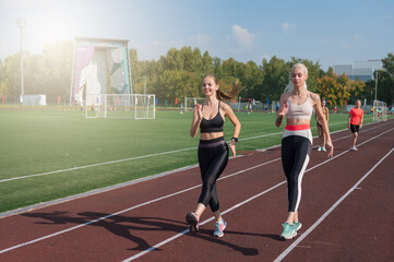 Two athlete young woman runner at the stadium