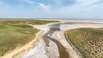 the salt river flows into the salt lake Baskunchak and creates a fantastic landscape view from a drone