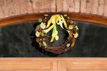 Easter decoration attached to the wooden door of an ancient building