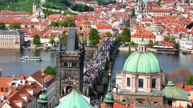 Charles Bridge is a medieval stone arch bridge that crosses the Vltava river in Prague, Czech Republic. Its construction started in 1357 under the auspices of King Charles IV.