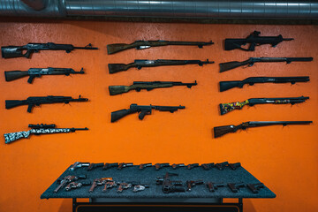 Firearms, rifles, pistol, revolvers and shotguns in a shooting range.