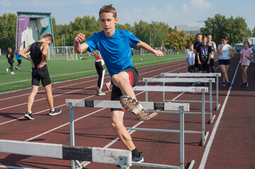 Group of young athletes training at the stadium. School gym trainings or athletics