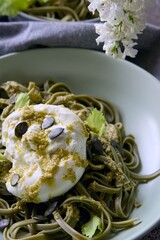 Green pasta with buratta cheese and pesto sauce
