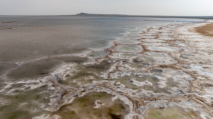 cosmic unreal landscapes of the Baskunchak salt lake on a spring day from the height of a drone flight
