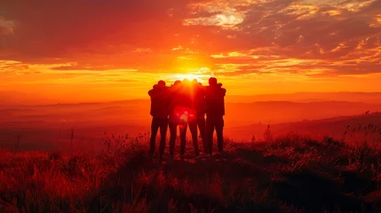 Behangcirkel  A group of friends standing on a hilltop watching the sunset. © Rattanathip