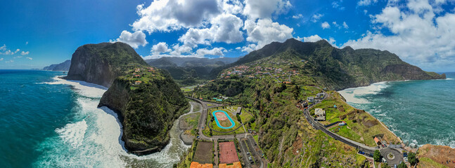 Madeira coast, green lush hills and Atlantic Ocean. Aerial drone view - obrazy, fototapety, plakaty