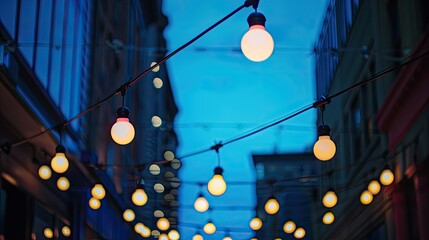 Under the deep blue evening sky street garlands featuring light bulbs suspended along black wires illuminate the streets