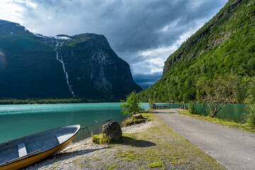 Mountain lake in Norway surrounded by mountains. Turquoise water of lake of glacial origin. The...