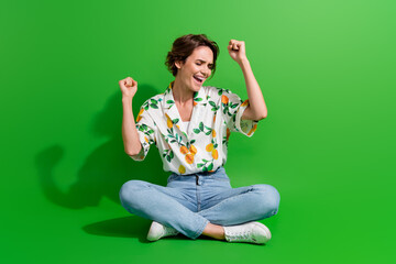 Fototapeta premium Full body picture of gorgeous young woman bob hair raised fists up celebrate she went vacation abroad isolated on green color background