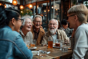 Group of senior friends talking and laughing while drinking beer at a pub