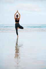 Balance, fitness and yoga with woman on beach for inner peace, mental health or wellness in...