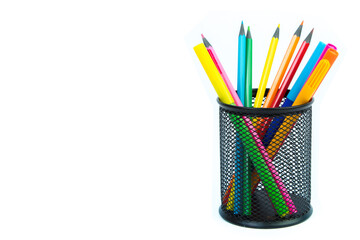 Pencils and felt-tip pens in a glass isolated on white background.
