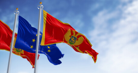 Montenegro and European Union flags waving in the wind on a clear day - 793028322