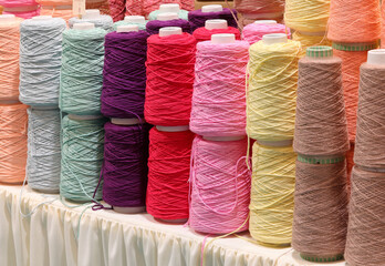 rolls of colored cotton wool thread during sale in a haberdashery counter