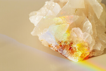 Quartz Prism's Rainbow Reflection at sunlight, close up of clear quartz crystal captures prismatic rainbow, natural facets and beauty of mineral. Minimal aesthetic nature pattern, beige pastel tone