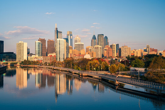 city skyline at sunset looks from over the river
