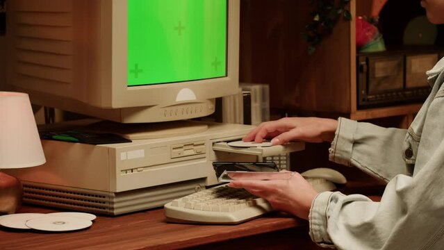 Retro PC with croma key green screen, Using vintage old computer. Dvd player, disc drive. Music recorder, playing retro computer games. 