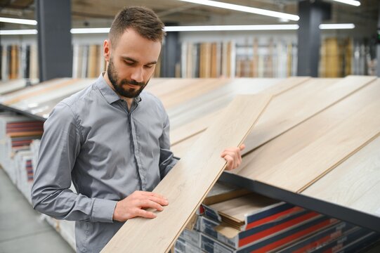 man choosing laminate samples in hardware store