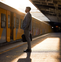 Businessman, travel and waiting for train with face mask for public transport, journey and...