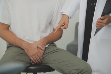 Male diseases. Man presses hands to his groin and suffering from pain, panorama, cropped, studio...