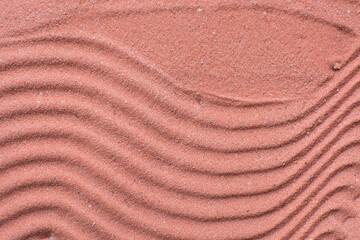 Lines drawn in coral sand background, beautiful sand texture, overhead view of brick orange sand, zen pattern drawn in the sand, Top view of fine grain texture