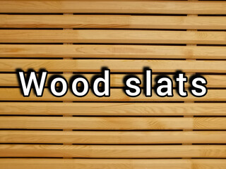 The inscription wooden slats on the background of a wooden surface made of slats