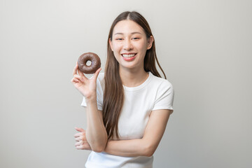 Portrait of pretty attractive asian young teenage woman holding chocolate, donut, doughnut, female...