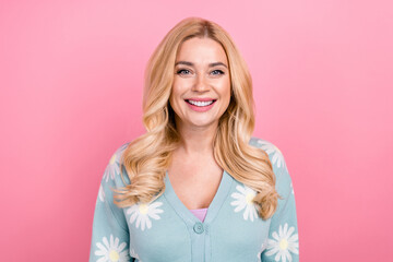 Portrait of gorgeous good mood nice person with curly hairstyle wear blue cardigan toothy smiling isolated on pink color background