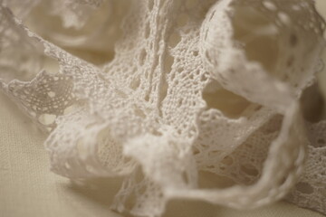 Fototapeta na wymiar Tender beige lace tape close up view
