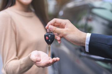 Business car rental, sell or buy service, dealership agent dealer sale hand giving auto key of...