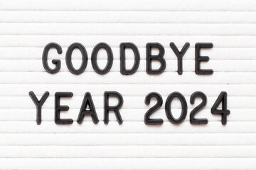Black color letter in word goodbye year 2024 on white felt board background