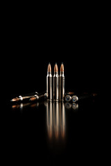 Obraz premium Bullet isolated on black background with reflexion. Rifle bullets close-up on black back. Cartridges for rifle and carbine on a black.